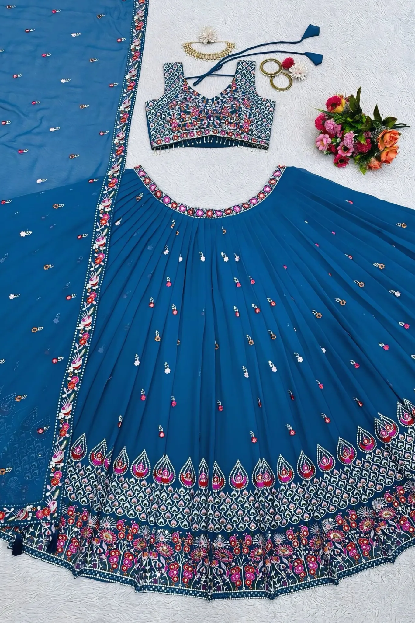 A CHOLI SLEEVELESS DESING THAT HIGHLIGHTS ELABORATE FLORAL AND GEOMETRIC PETTERNS